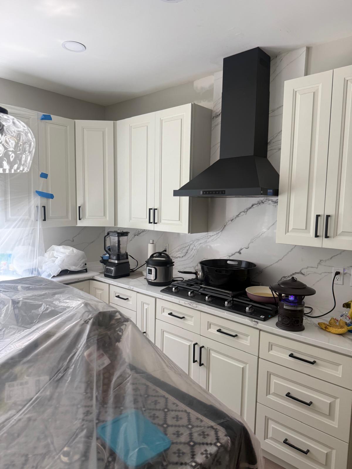 Cream Cabinetry with Marble Backsplash